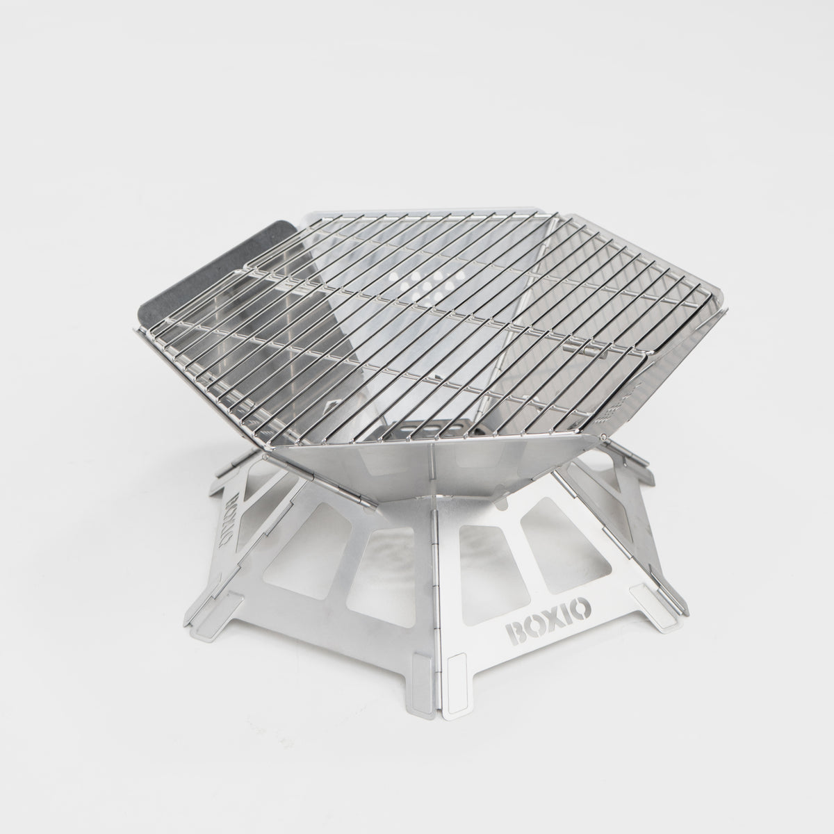Kompakter, tragbarer Edelstahl-Grill mit hexagonaler Form und stabiler Unterkonstruktion. Ideal für Outdoor-Aktivitäten.