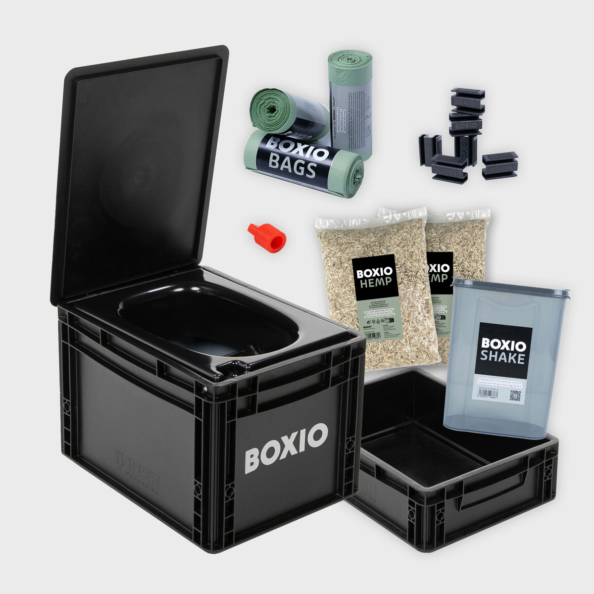 Schwarze Box mit offener Klappe, gefüllt mit BOXIO-Produkten: Bioplastiktüten, Hanf, Shake und Zubehör.