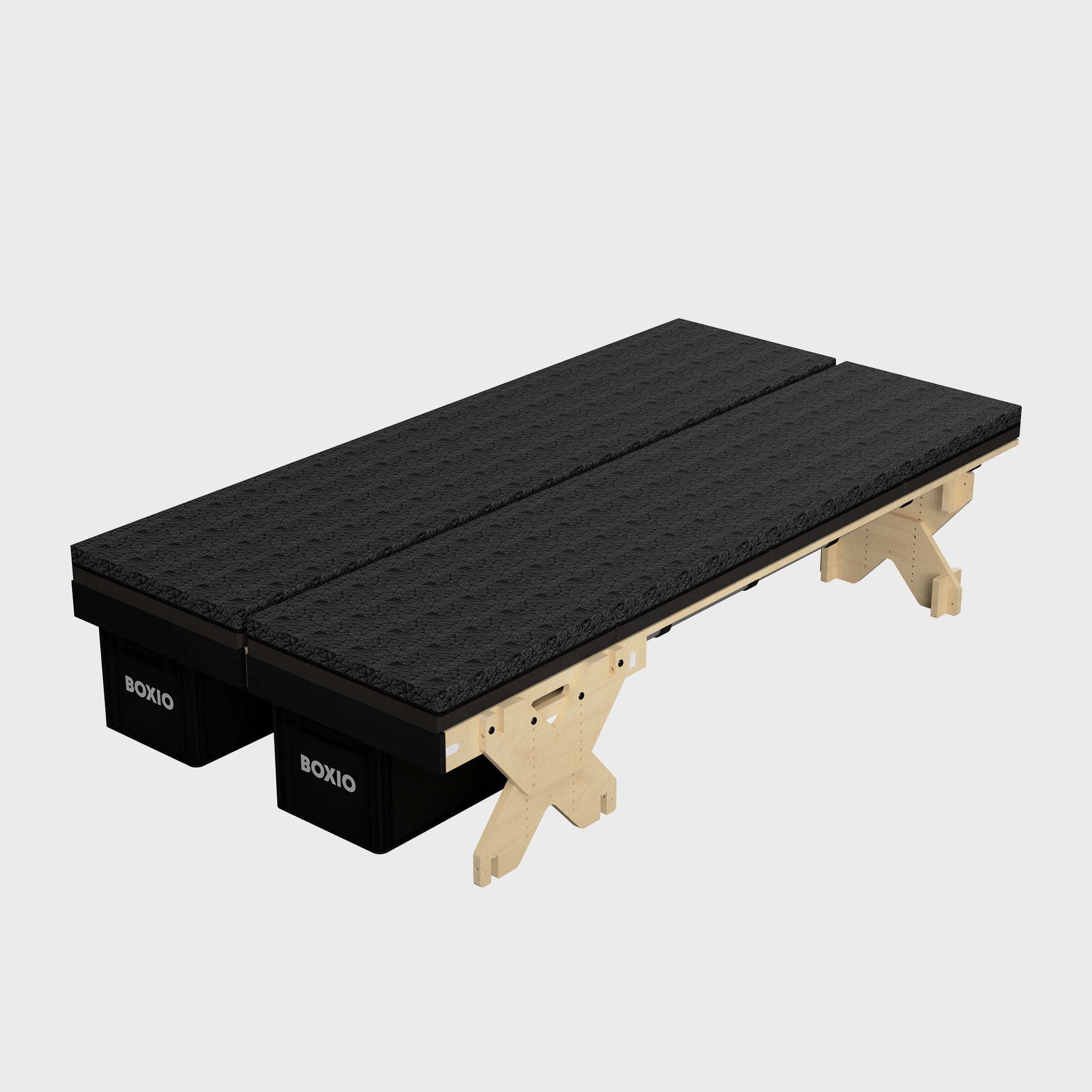 Schwarzes Boxspringbett mit Holzuntergestell und zwei stabilen Basiselementen, modern und funktional.
