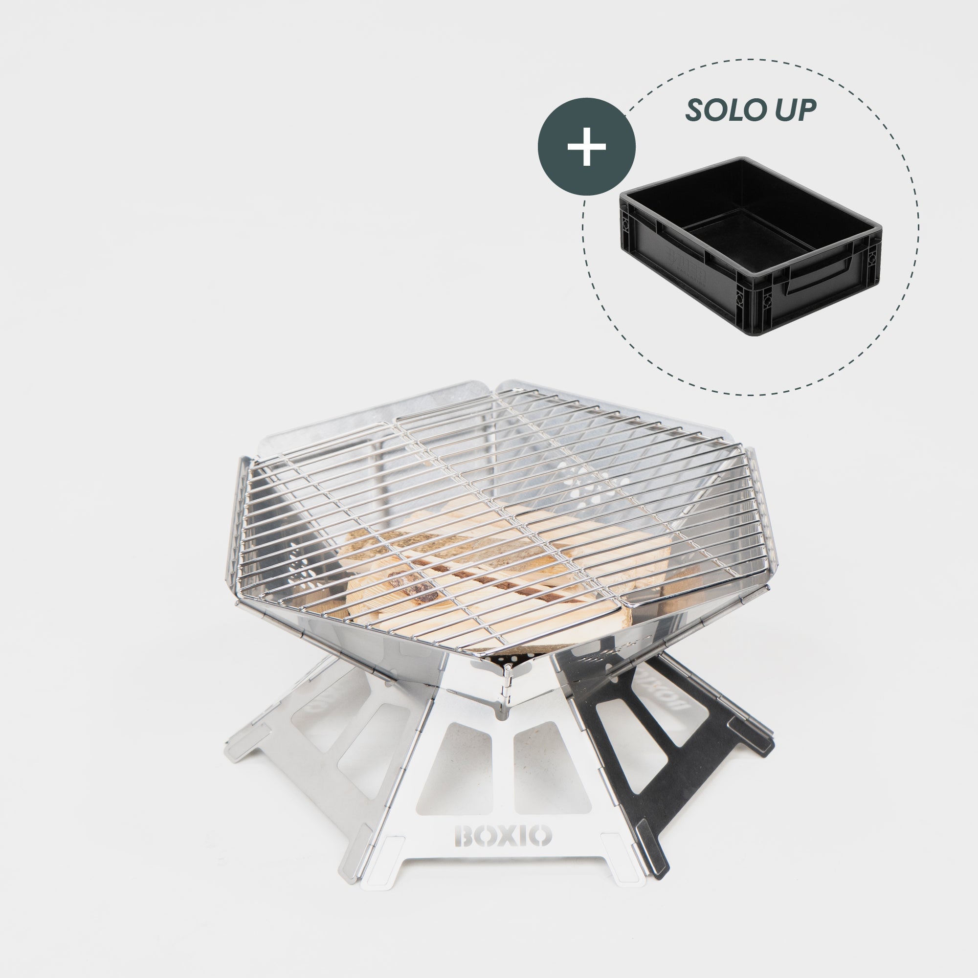 Robuster Edelstahl-Grill mit Holzkohleschicht und Grillrost, daneben schwarzer Aufbewahrungskasten.