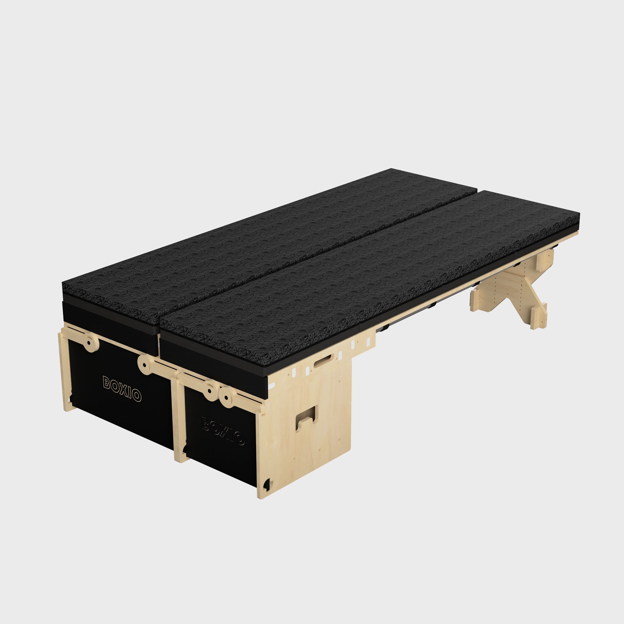 Modulares Schlafsystem mit zwei schwarzen Matratzen auf einer stabilen Holzstruktur. Ideal für flexible Schlaflösungen.